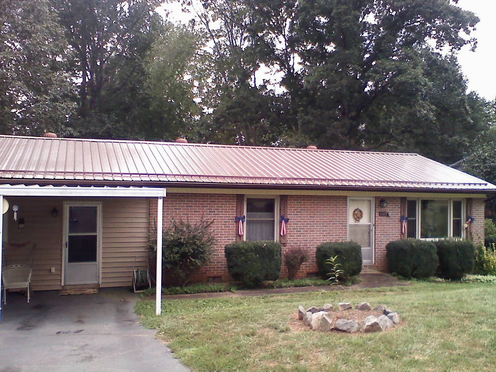 Bronze metal roof and carport on a brick ranch home — Roof Repair work by our crew in Beverly Hills